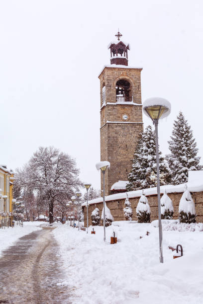 Street view with church bell tower covered with snow, Bansko, Bulgaria