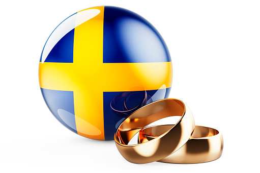 Weddings in Sweden concept. Wedding rings with Swedish flag. 3D rendering isolated on white background