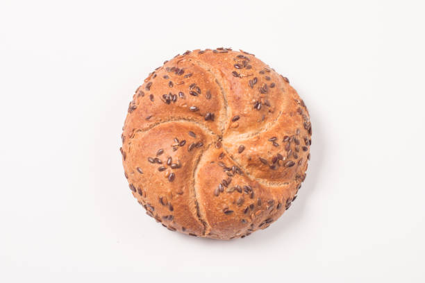 Wholemeal breads and a colored napkin on a white background with copy space