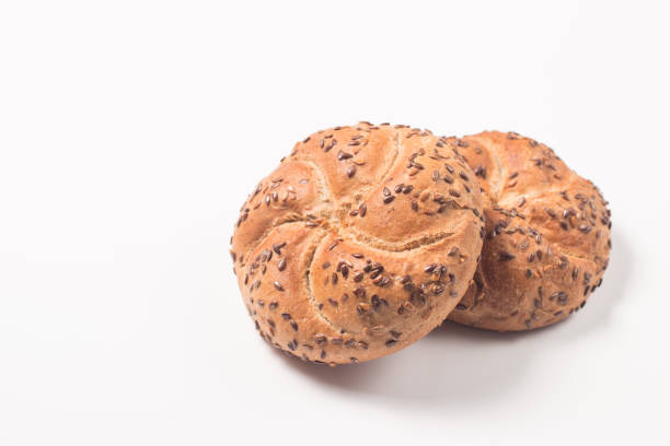 Fresh bread with seeds on a white table background. Bakery. Food security concept.