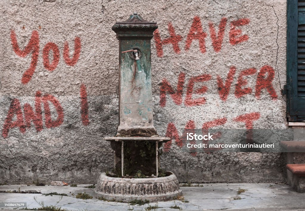 you and I never met "you and I have never met" is graffitied on an old rough wall Antique Stock Photo