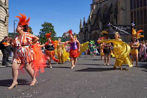 Bath, England, United Kingdom - 9 July 2022: Dancers in ornate costumes performing at the annual carnival as it progresses through the streets of the historic city of Bath in Somerset.