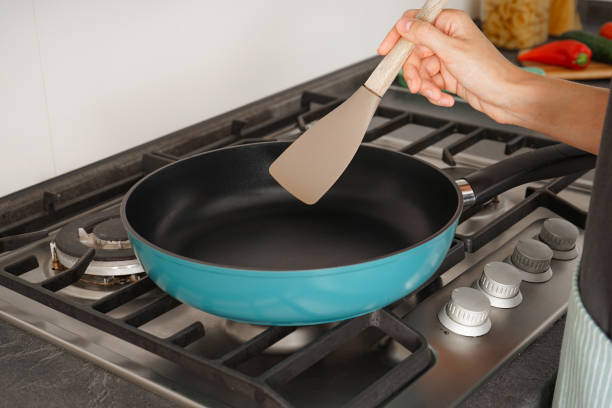 Frying pan on a gas stove, preparing to cook in the kitchen. Close-up. stock photo