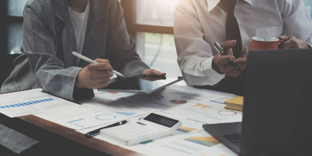 istock Business people share their experiences of collaboration using a tablet, take notes at the office. 1408652376
