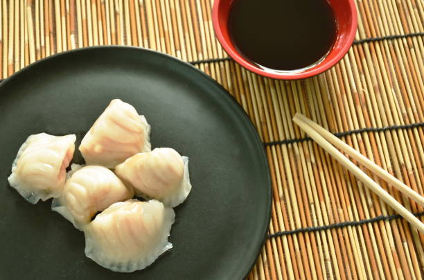 Ha Kao or white dumpling stuffed shrimp and pork  dipping soy sauce stock photo