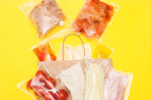 istock Salad dinner set: chicken, lettuce, tomatoes, peking cabbage, cheese, bacon, bread, olive oil sauces and spices. A set for delivering food for dinner on a yellow background. I cook at home. 1408656101