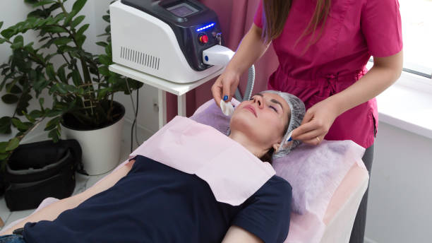 istock Beauty salon worker wipes client's face with cotton pads 1408658103