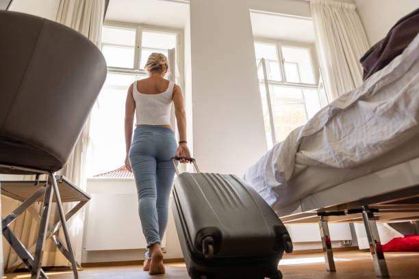 istock Young woman checking in hotel room 1408659800