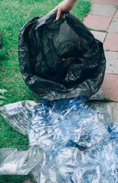 istock Empty rumpled used blue plastic bottles and black bag 1408661115