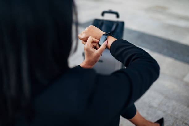 istock An unrecognizable female entrepreneur is sitting on a bench and using a smart watch 1408661798