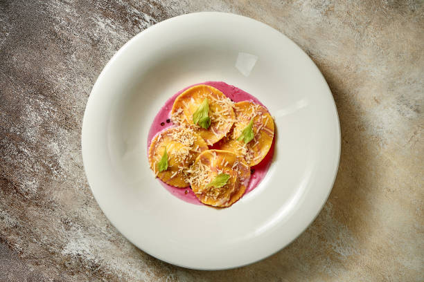 Ravioli with stuffing in pink sauce. Close-up. Selective focus. Noise in post-production