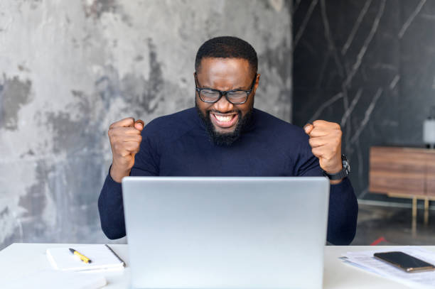 istock Overjoyed African-American man celebrates victory 1408664457