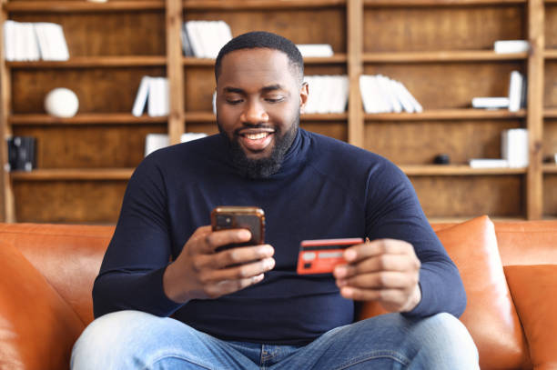 istock Happy African-American man using a smartphone for online shopping 1408664503