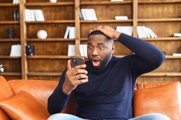 istock Shocked African-American man with a smartphone 1408664515
