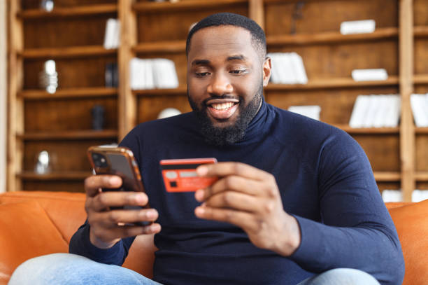 Happy African-American man using a smartphone for online shopping