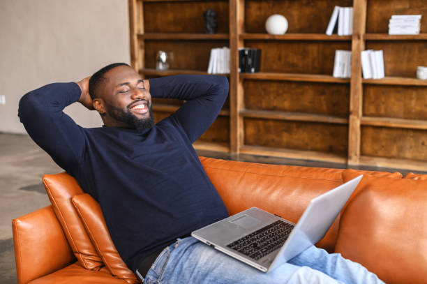 istock Satisfed African-American man rests at the workplace 1408664523