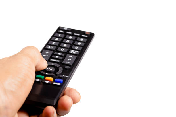 istock Man hands holding TV remote control isolated on white background with clipping path 1408665999