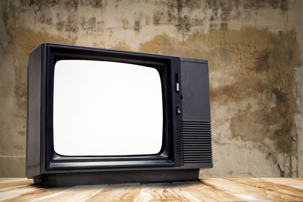 istock Vintage, black old television on wood table with cut out screen on old wall background 1408666112