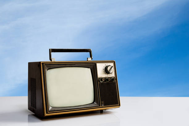 istock Vintage, Old television on white table with blue sky background. Retro TV  technology 1408666141