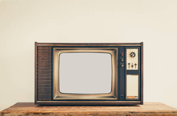 istock Retro old TV on wooden table with cut out screen on white background, vintage filter effect 1408666324