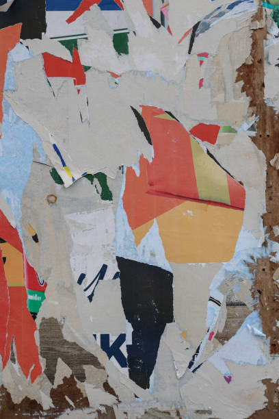 istock Pieces of torn paper peeling off wall used as billboard 1408670132