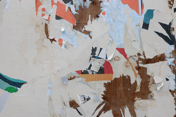 istock Pieces of torn paper peeling off wall used as billboard 1408670216