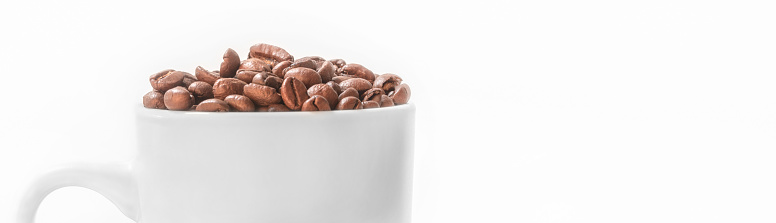 White Cup of Coffee Full of Fresh Roasted Coffee Beans Isolated on White Background with Copy Space