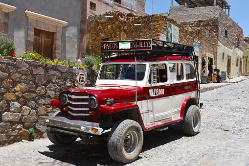 Real del Catorce, Mexico - May 5 2022: Diagonal shot of a red and white Willys Jeep