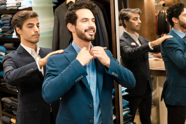 istock Young male owner helping customer wearing jacket 1408676703