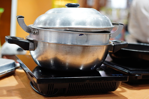 Steamed food on hot coal in stove