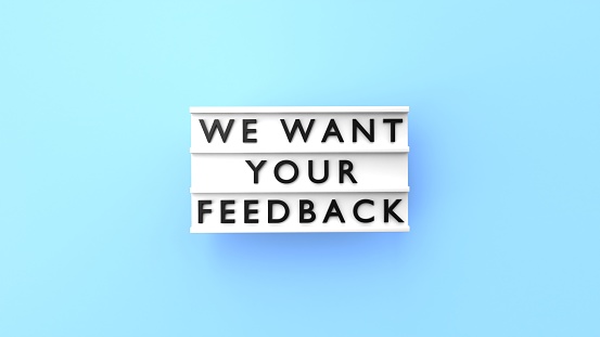 We Want Your Feedback Text is Displaying on a Lightbox on Blue Background
