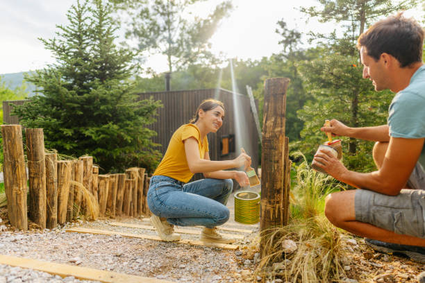 istock Painting together a wooden path fence 1408682309