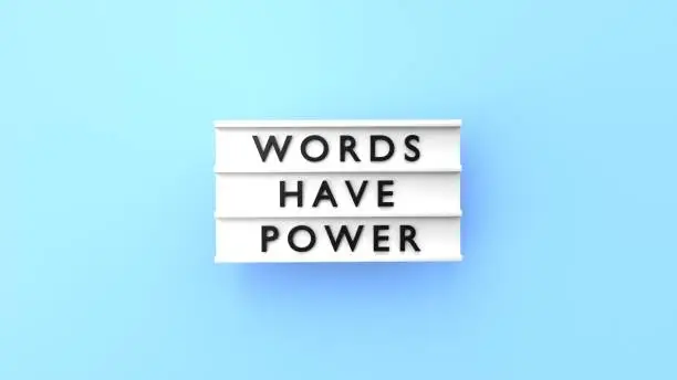 Words Have Power text is displaying on a vintage letter board lightbox against blue background. Easy to crop for all your social media and print sizes.