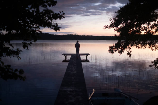 istock Young Woman on a Dock after Sunset. 1408685891