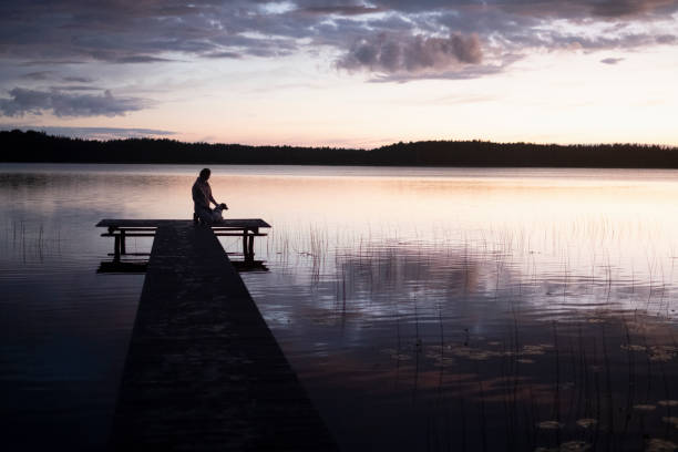 istock Young Woman on a Dock after Sunset. 1408686073