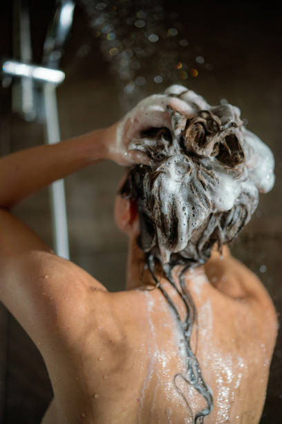 istock Woman washing hair with shampoo 1408686685