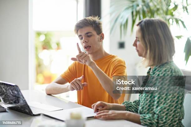 Deaf Teenage Boy Signing While Elearning From Home Stock Photo - Download Image Now