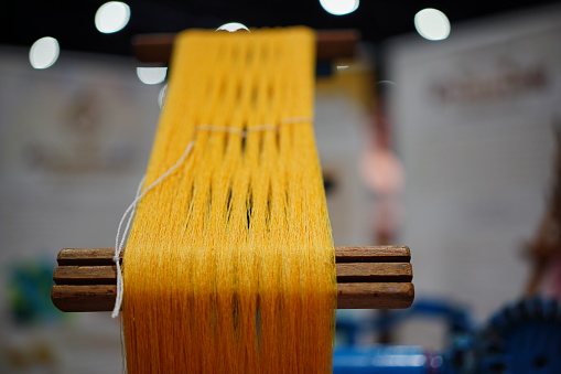 Close-up of golden Thai silk thread texture background