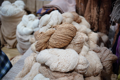 Group of handmade cotton thread bundle in wooden basket