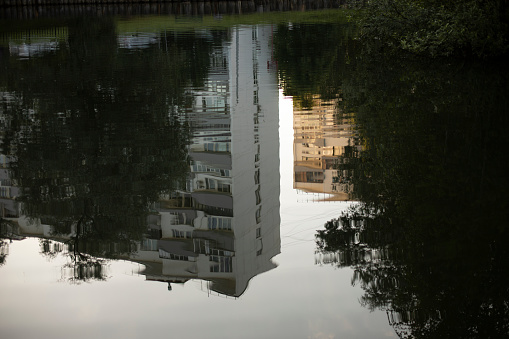 Reflection in puddle. House is reflected in water. in Moscow, Moscow, Russia