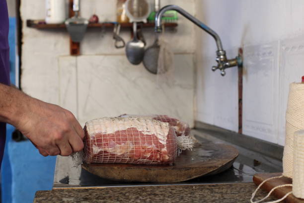 man preparing meat for smoking