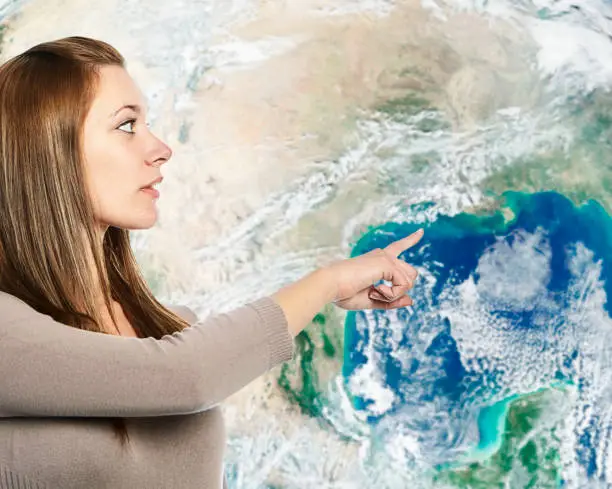 Young woman gestures towards the Gulf of Mexico on a satellite image of Earth behind her.

Public domain Earth image from https://www.nasa.gov/multimedia/imagegallery/image_feature_2159.html