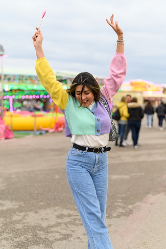 Young woman in casual clothing enjoying a day at the amusement park