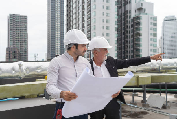 istock Engineer men or worker team, people working in industry factory. Chiller tower on rooftop building. System work machine. Condenser Water Supply pipe lines. Ventilation compressor 1408699744