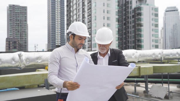 istock Engineer men or worker team, people working in industry factory. Chiller tower on rooftop building. System work machine. Condenser Water Supply pipe lines. Ventilation compressor 1408699827