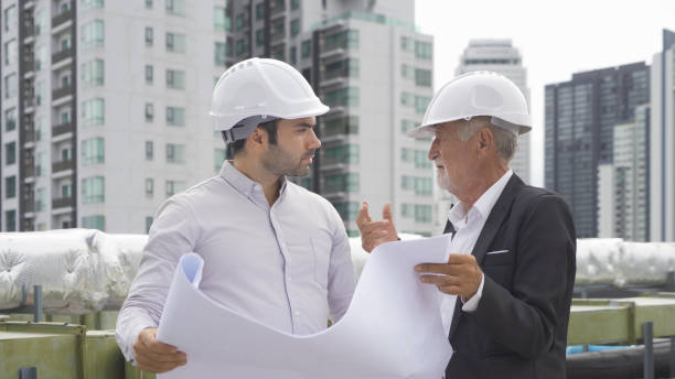 istock Engineer men or worker team, people working in industry factory. Chiller tower on rooftop building. System work machine. Condenser Water Supply pipe lines. Ventilation compressor 1408699858