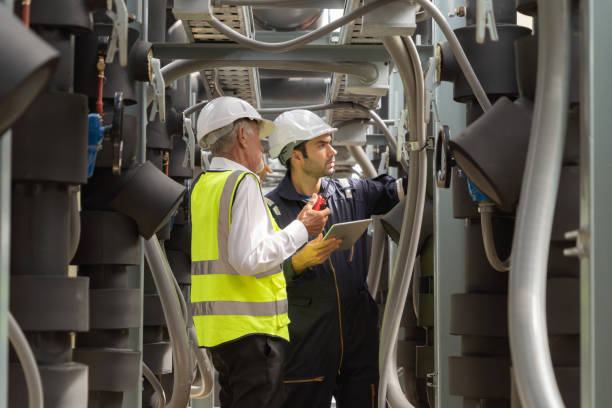 istock Engineer men or worker team, people working in industry factory. Chiller tower on rooftop building. System work machine. Condenser Water Supply pipe lines. Ventilation compressor 1408700561