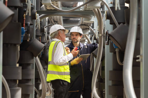 istock Engineer men or worker team, people working in industry factory. Chiller tower on rooftop building. System work machine. Condenser Water Supply pipe lines. Ventilation compressor 1408700581