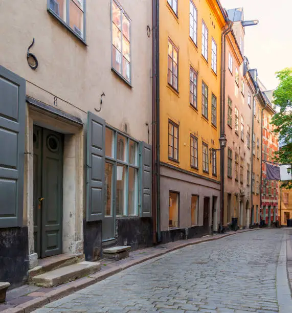 Photo of Narrow alley in Gamla stan, the old town of Stockholm, Sweden with old style colorful houses and cobblestone street