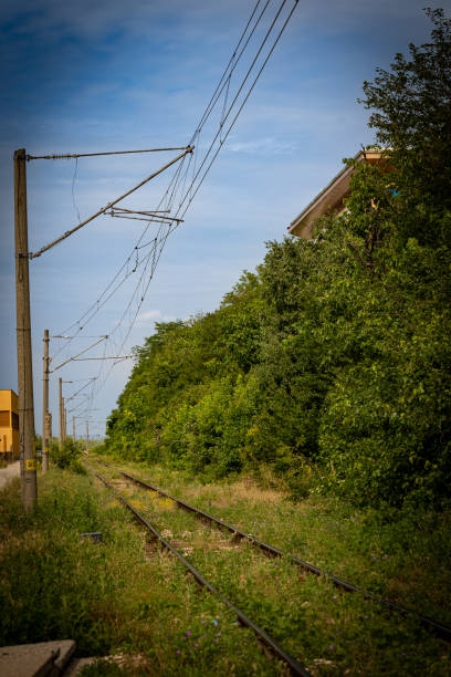 istock Curved of a railroad track equipped with electrical wiring. 1408706532